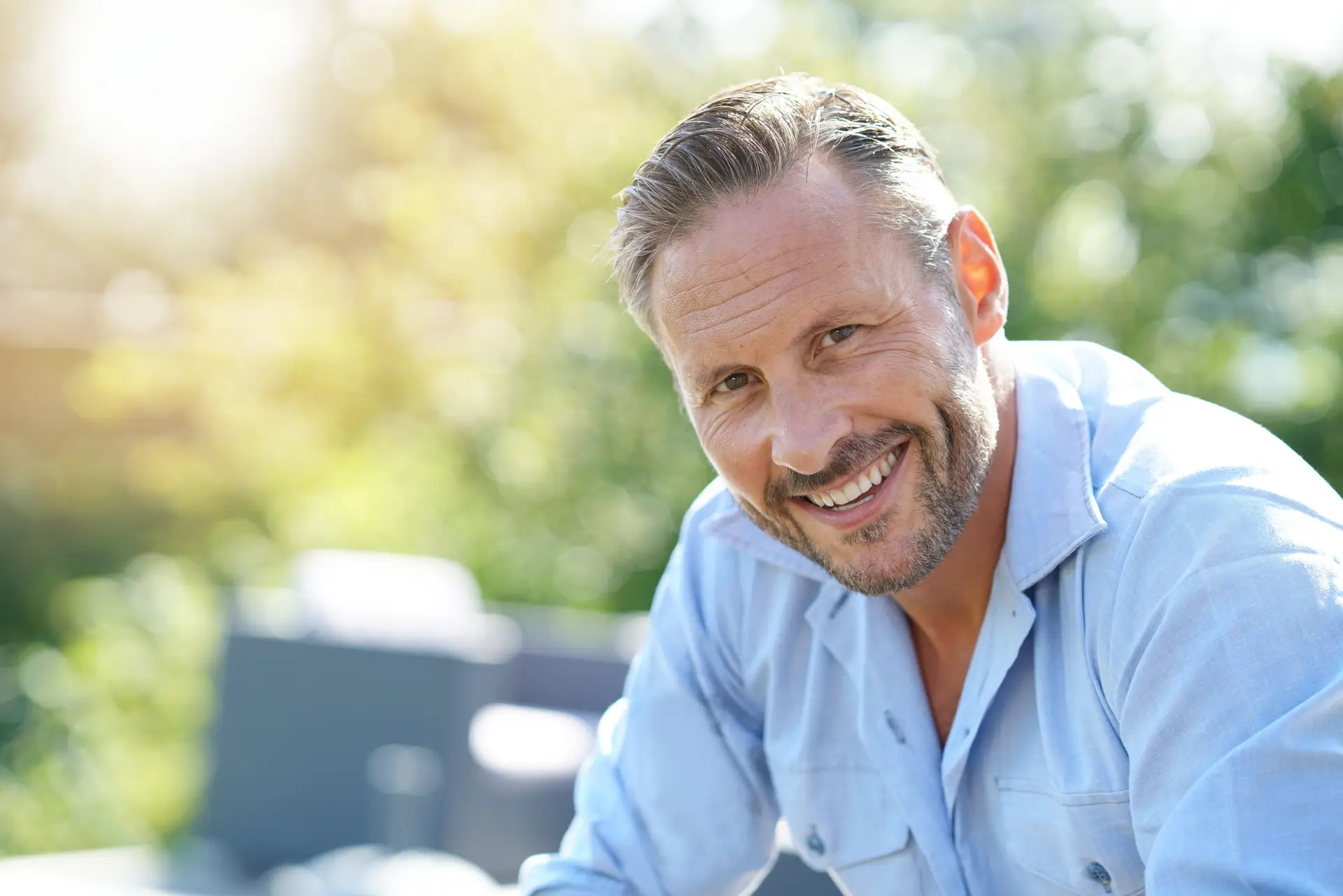 Smiling patient at an oral cancer screening visit at Olympic Park Smiles Dental in Calgary