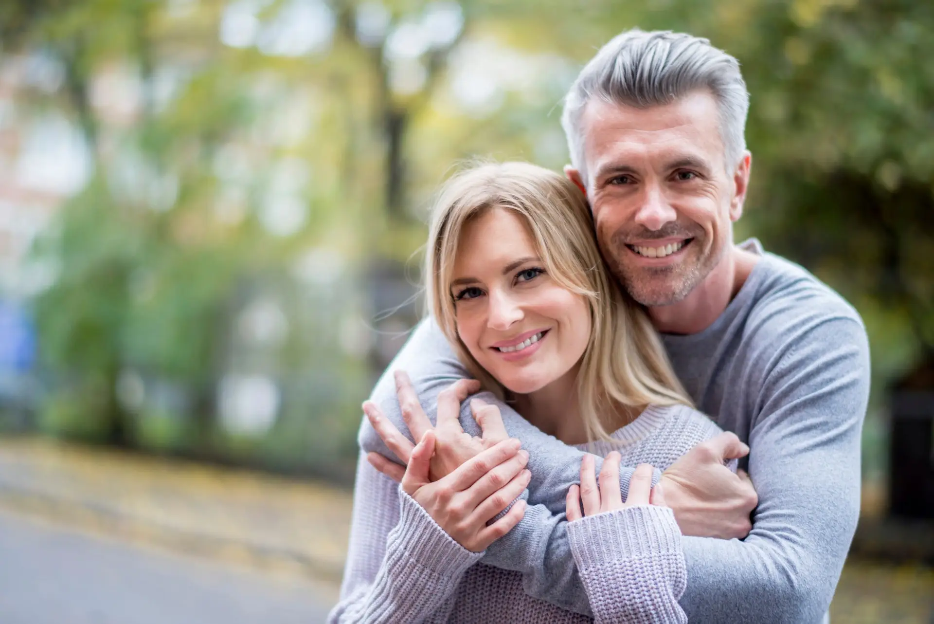 Smiling couple after composite bonding treatment at Olympic Park Smiles Dental in Calgary