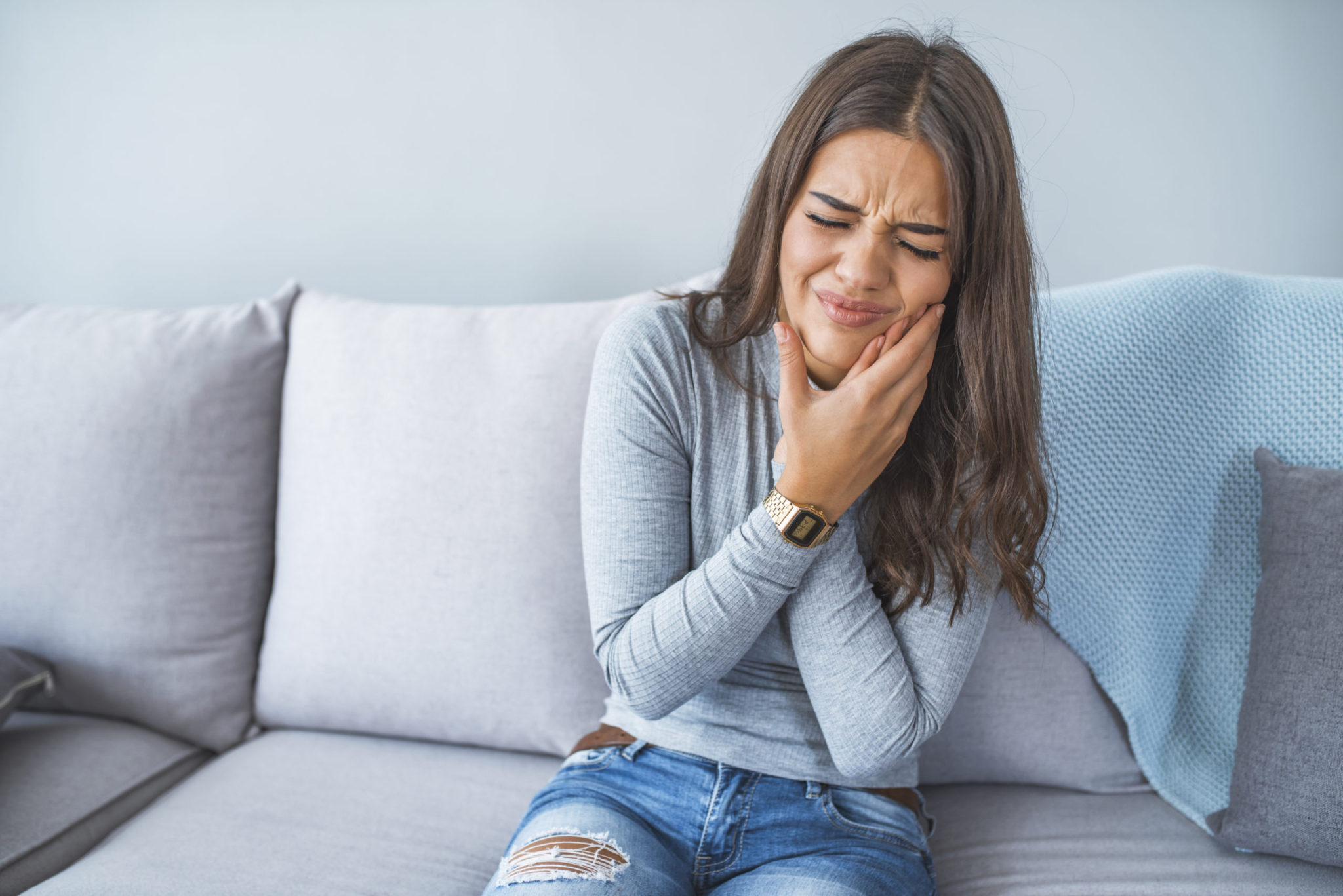 Patient with tooth pain visiting Olympic Park Smiles Dental for root canal treatment in Calgary
